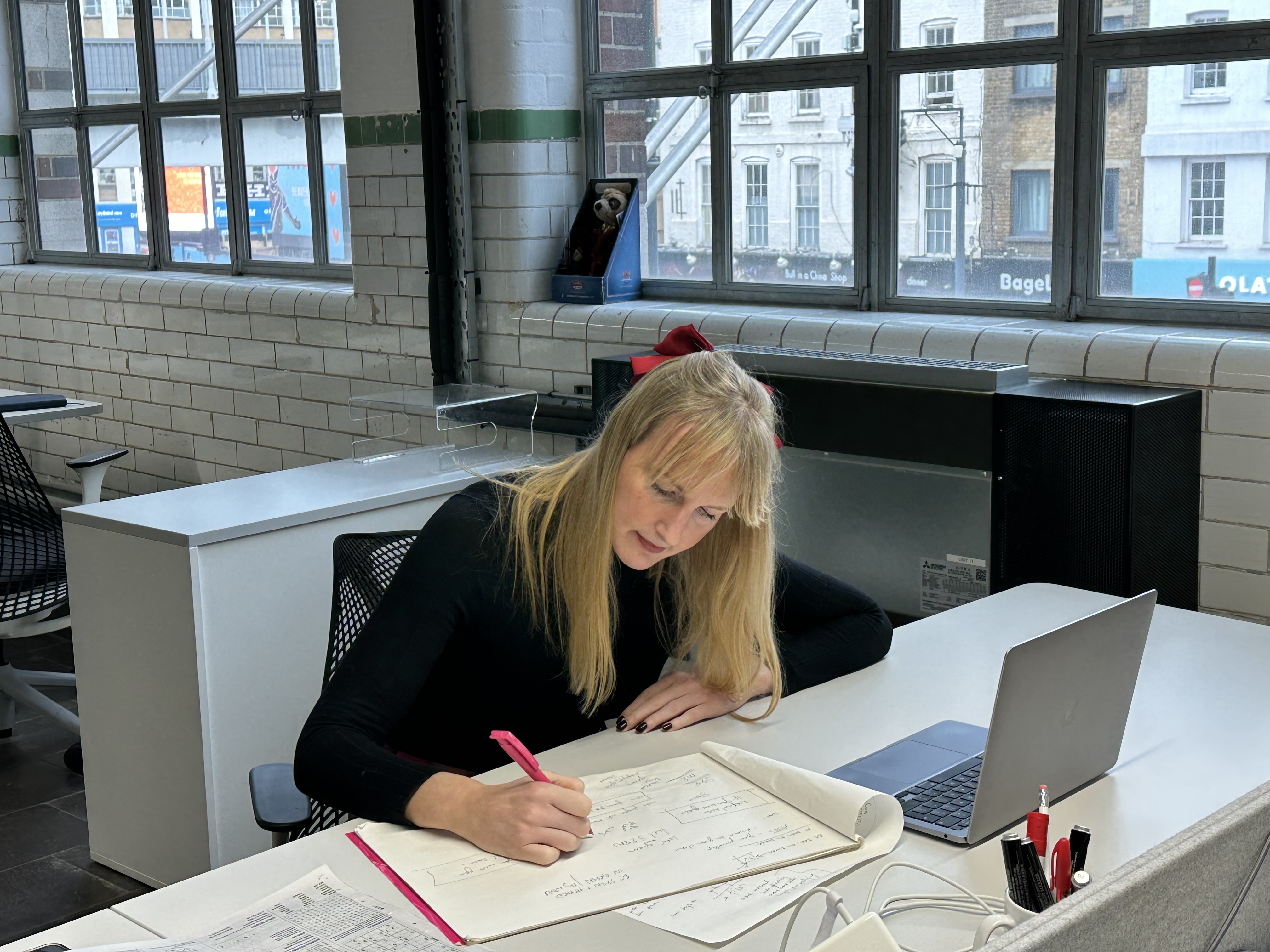 woman at a desk with a sketchbook