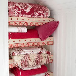 room with linen storage white cupboard