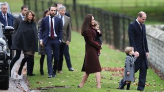 Prince William, Kate, Prince George and Princess Charlotte followed by Carole, James and Michael Middleton arrive to attend the service at St Mark's Church on Christmas Day on December 25, 2016