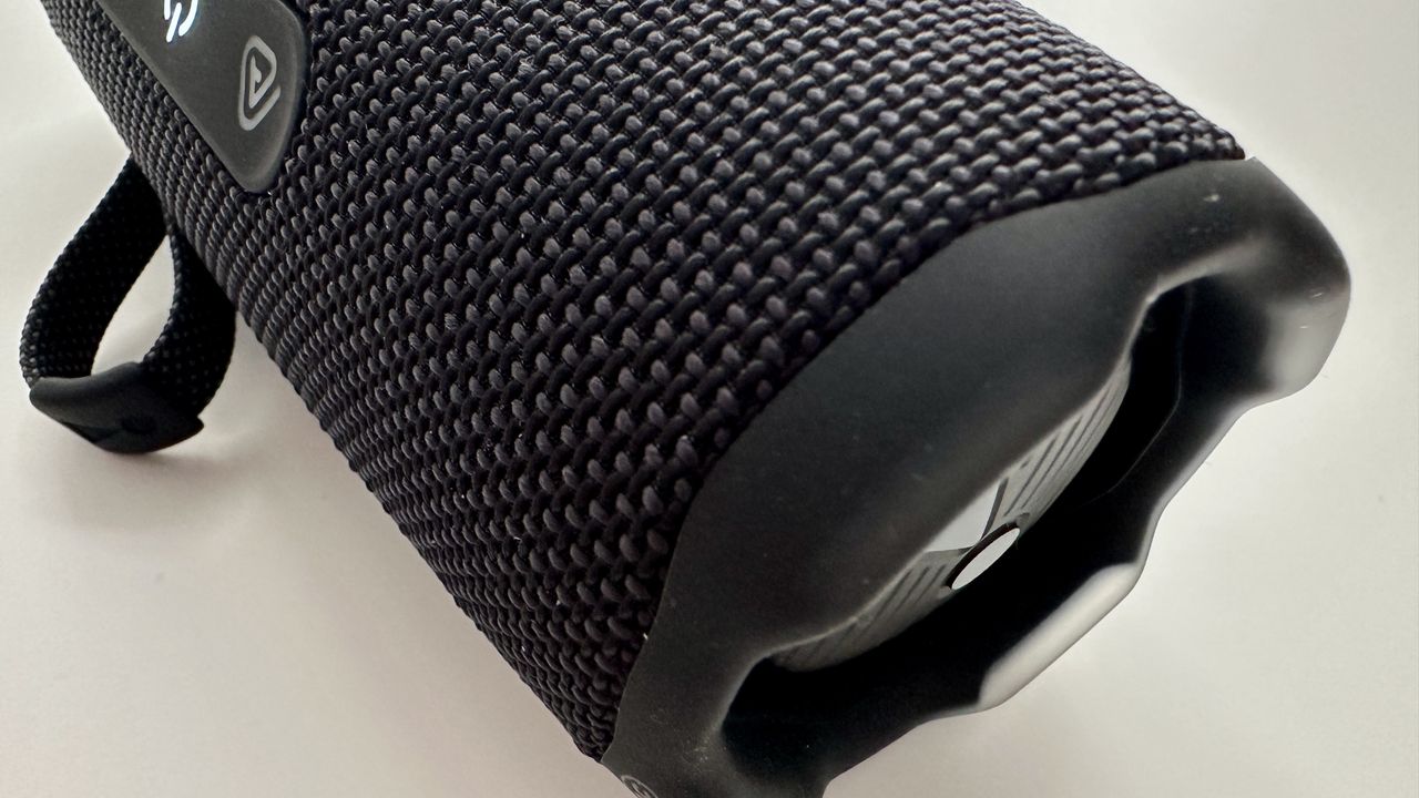 JBL Flip 7 portable Bluetooth speaker end panel laid flat on a white surface