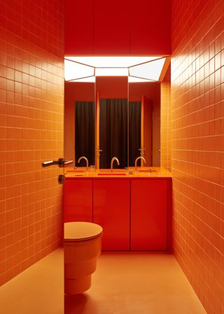 A color-drenched, tangerine orange bathroom