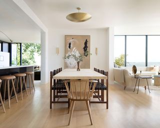 Open plan dining room with pale ash wood and leather and metal accents