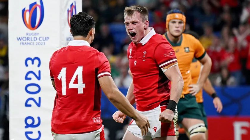 Rugby player celebrating with teammate