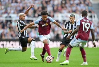 oubacar Kamara of Aston Villa is challenged by Joelinton of Newcastle United during the Premier League match between Newcastle United and Aston Villa at St. James Park on August 12, 2023 in Newcastle upon Tyne, England. (Photo by Stu Forster/Getty Images)