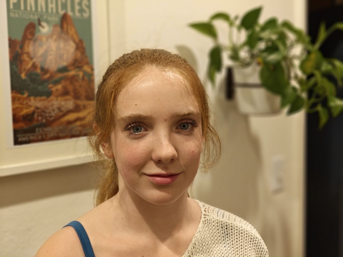 Portrait shot at night indoors of teenager by OnePlus 13R