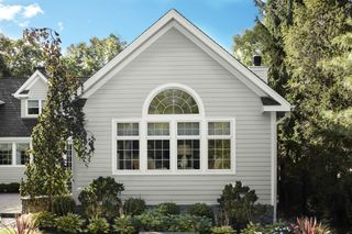 The exterior of a house painted in a light gray color