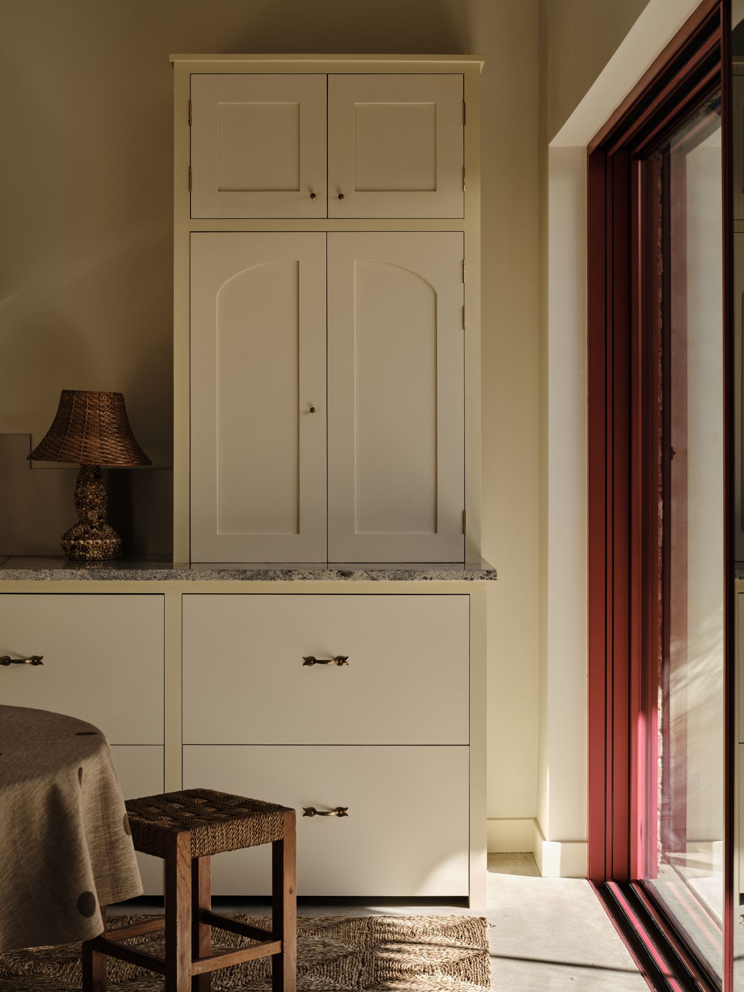 Kitchen cabinetry with white doors and a butter yellow trim surrounding them