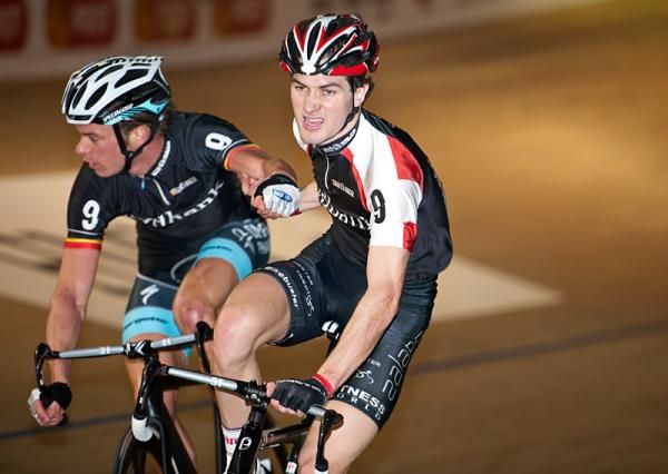 Illjo Keisse takes a handsling from teammate Marc Hester as things heat up in the Madison.
