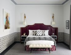 hotel bedroom with white walls and oriental inspired details and headboard