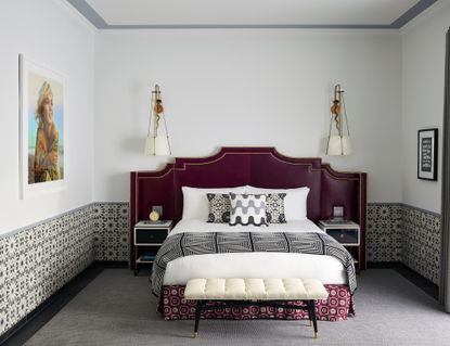 hotel bedroom with white walls and oriental inspired details and headboard