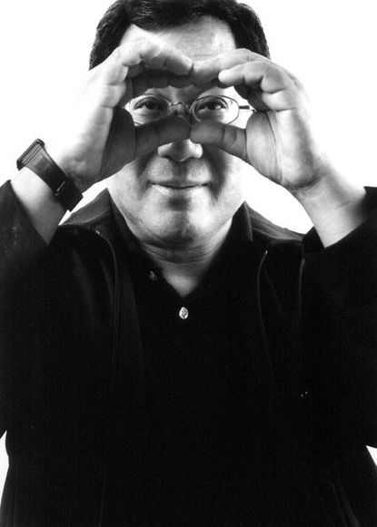 A man wearing glasses looking through his hands