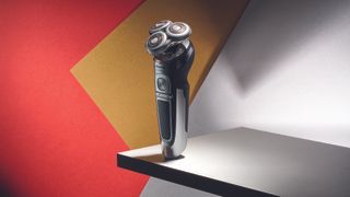 The best electric shaver on a red, gold and white abstract background