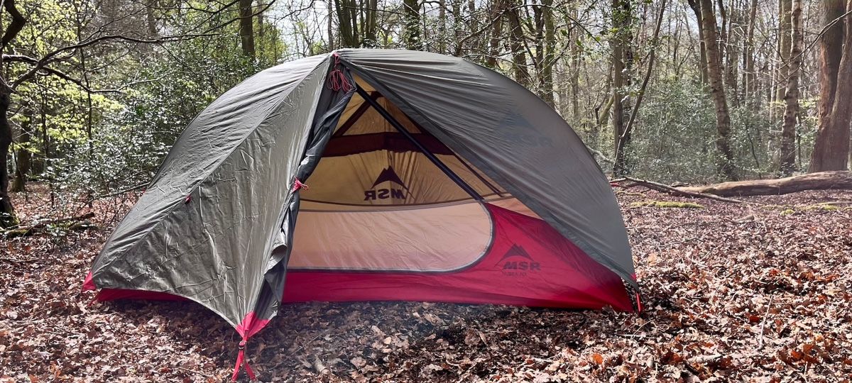 MSR Hubba NX tent with front open, pitched in woods