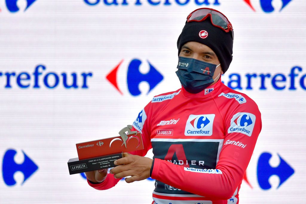 Team Ineos rider Ecuadors Richard Carapaz celebrates on the podium retaining the overall leaders red jersey after the 7th stage of the 2020 La Vuelta cycling tour of Spain a 1597 km race from VitoriaGasteiz to Villanueva de Valdegovia on October 27 2020 Photo by ANDER GILLENEA AFP Photo by ANDER GILLENEAAFP via Getty Images