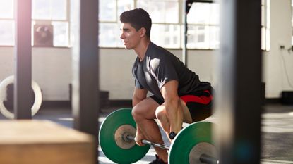 Deadlifts man at bar