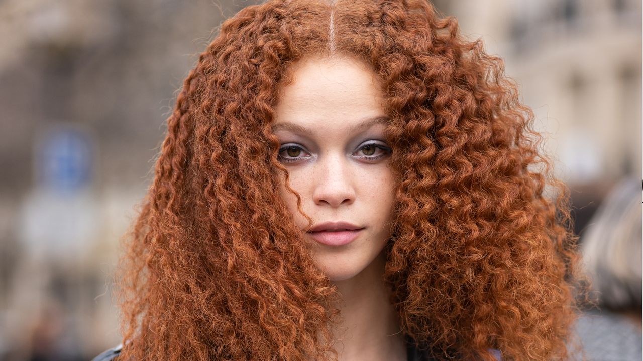 A guest with curly hair is seen outside Chanel, during Paris Fashion Week - Womenswear Fall Winter 2023 2024, on March 07, 2023 in Paris, France