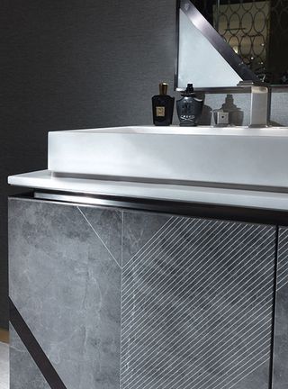 Detail view of grey marble and brushed steel bathroom cabinet