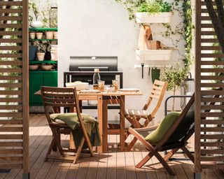 An outdoor dining set with a folding table on a decked terrace