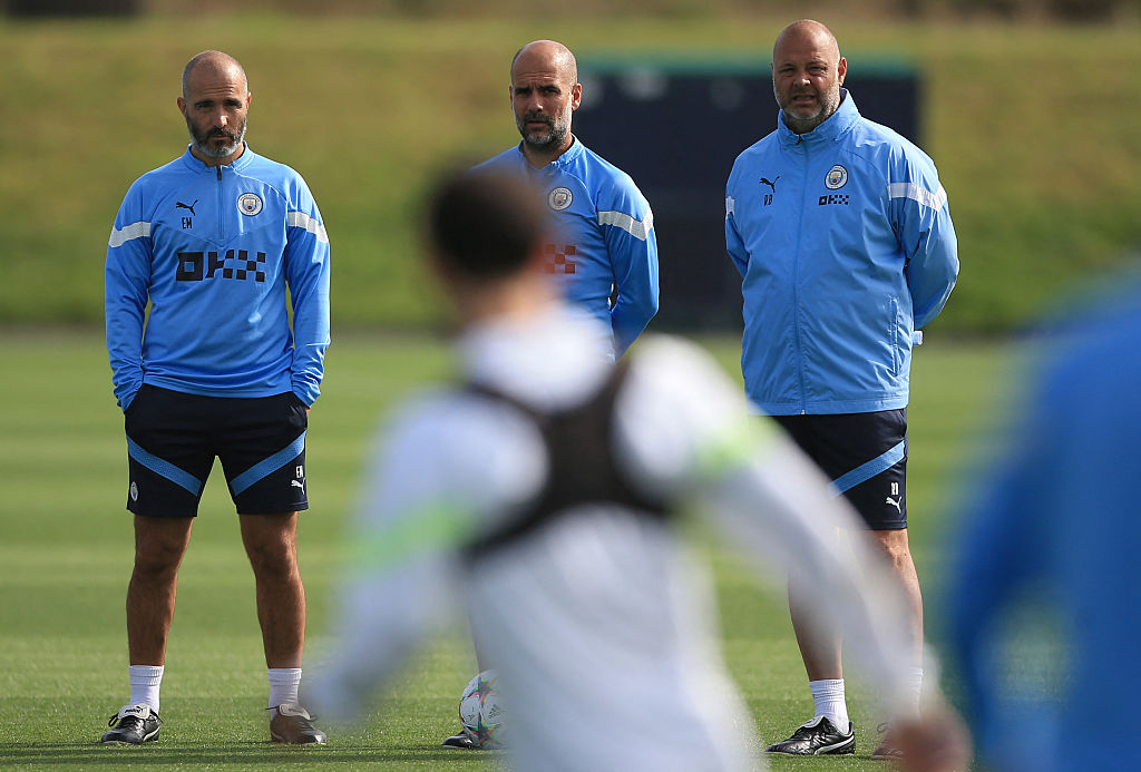 Manchester City's manager Pep Guardiola (C), assistant manager Enzo Maresca (L) and assistant manager Rodolfo Borrell attend a training session