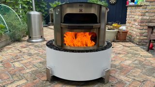 fire pit lit to light up the Breeo Live Fire pizza oven