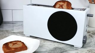 The Xbox Series S Toaster on a kitchen countertop with a slice of toast.