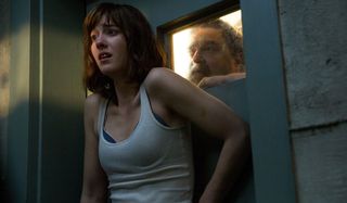 10 Cloverfield Lane Michelle shocked with Howard peering from behind the door