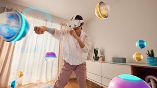 An official lifestyle image of someone playing a mixed reality game on a Meta Quest 3S