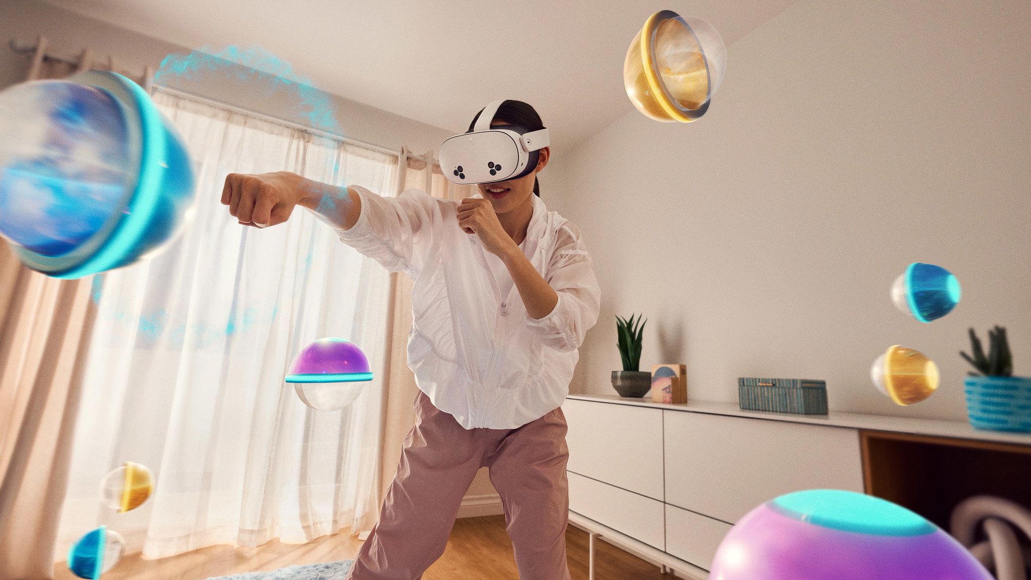 An official lifestyle image of someone playing a mixed reality game on a Meta Quest 3S