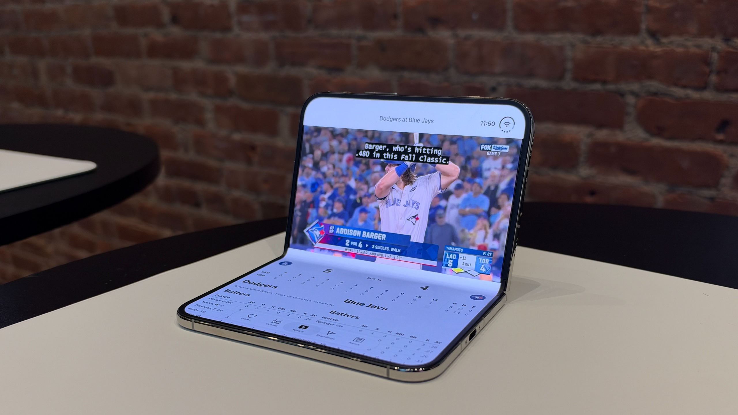 MLB App on iPhone Duo, in seated pose