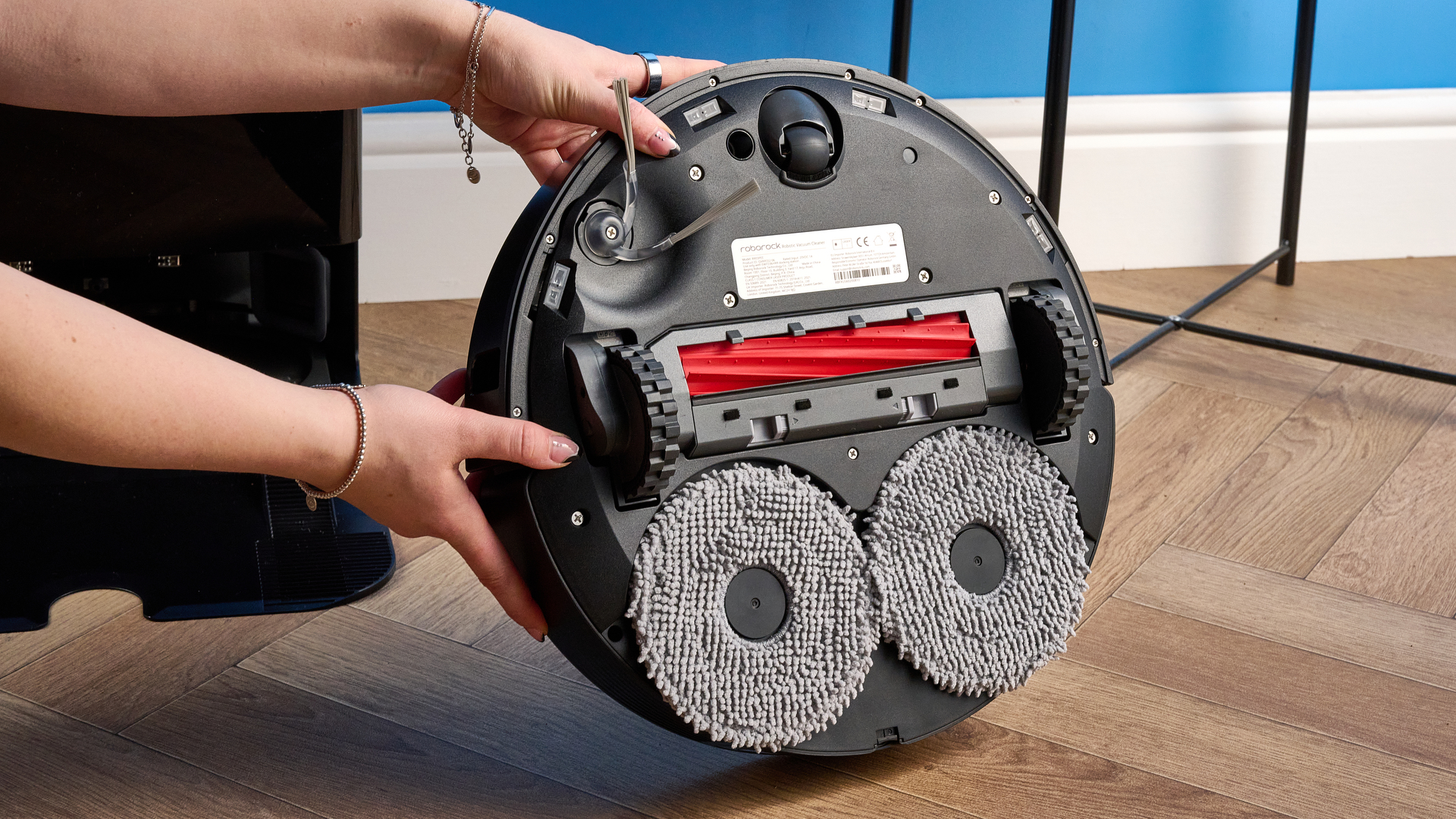 Underside mops of the Roborock QV 35S held up and photographed in front of a blue background