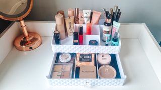A collection of makeup in a makeup organizer
