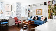 An open plan living room connected to a small kitchen