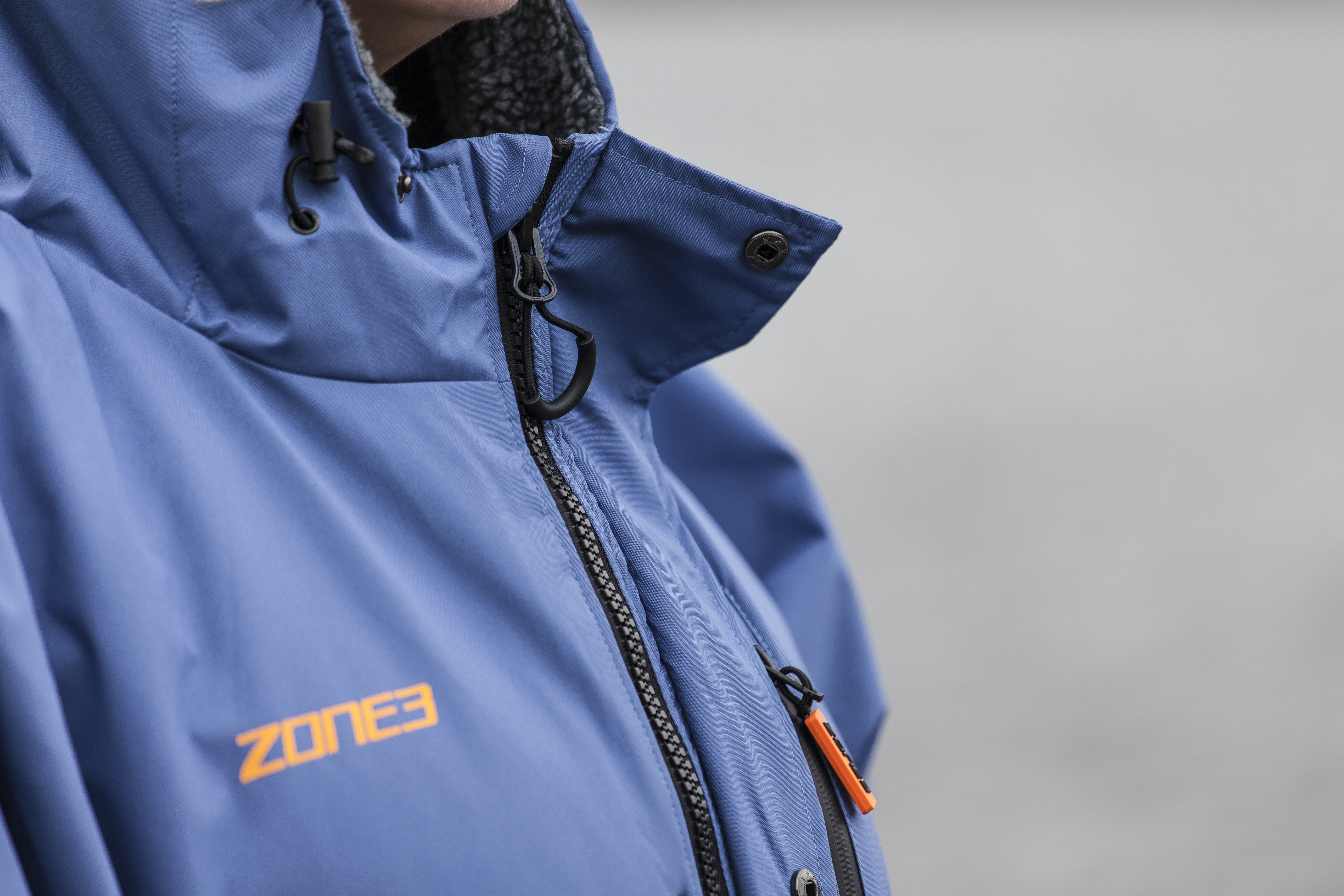 Woman standing in Grasmere lake wearing Zone3 thermotech changing robe