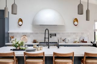 a modern kitchen with a domed plaster cooker hood