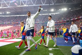 Ezri Konsa of England acknowledges the fans as he walks out of the tunnel with teammates prior to the UEFA EURO 2024 quarter-final match between England and Switzerland at Düsseldorf Arena on July 06, 2024 in Dusseldorf, Germany.
