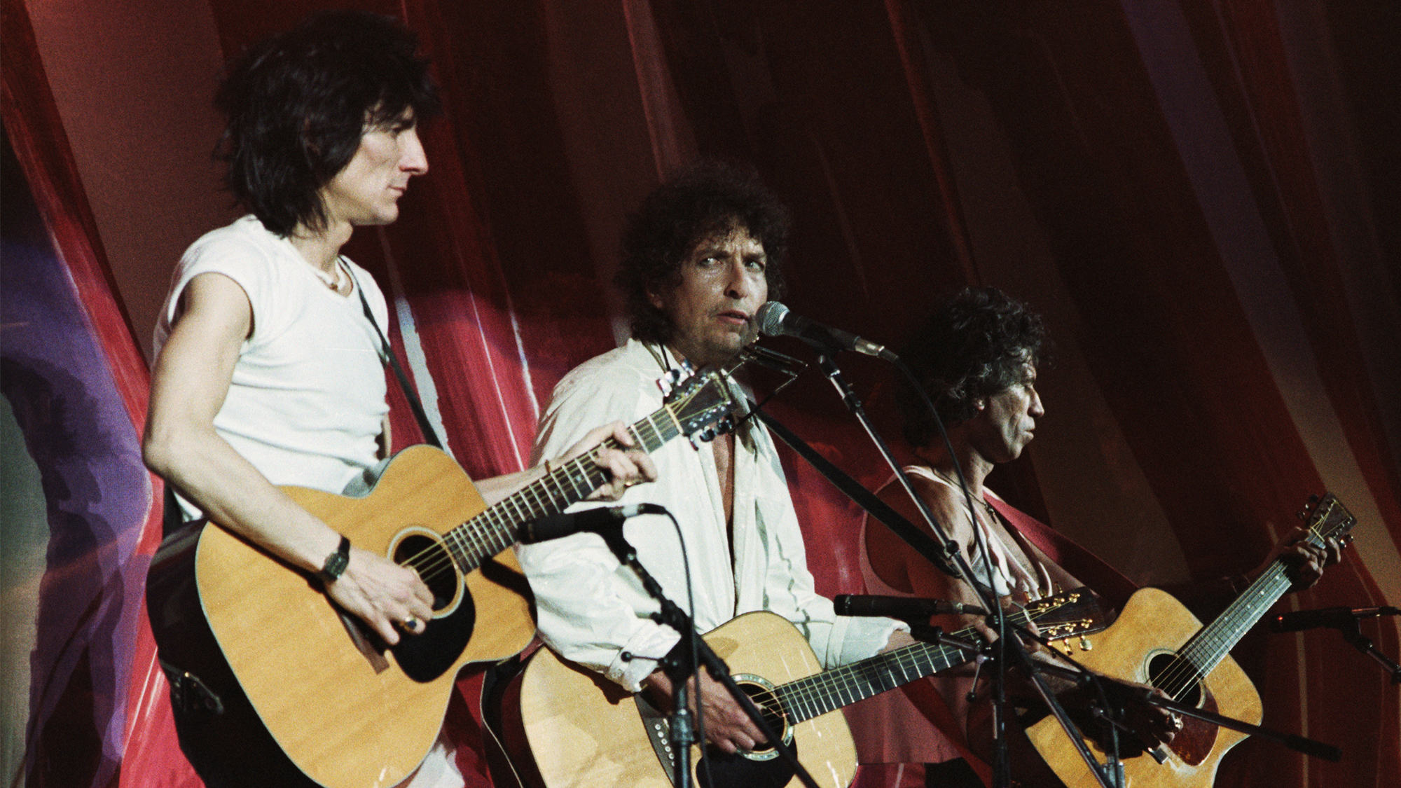 (from left) Ron Wood , Bob Dylan and Keith Richards perform at Live Aid, July 13, 1985, at JFK Stadium in Philadelphia