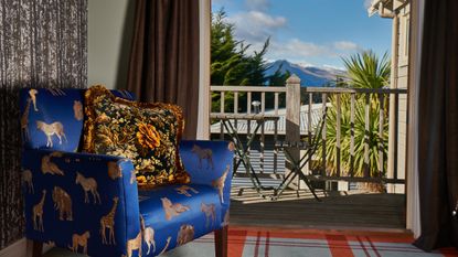 Dark blue chair overlooking mountains in New Zealand