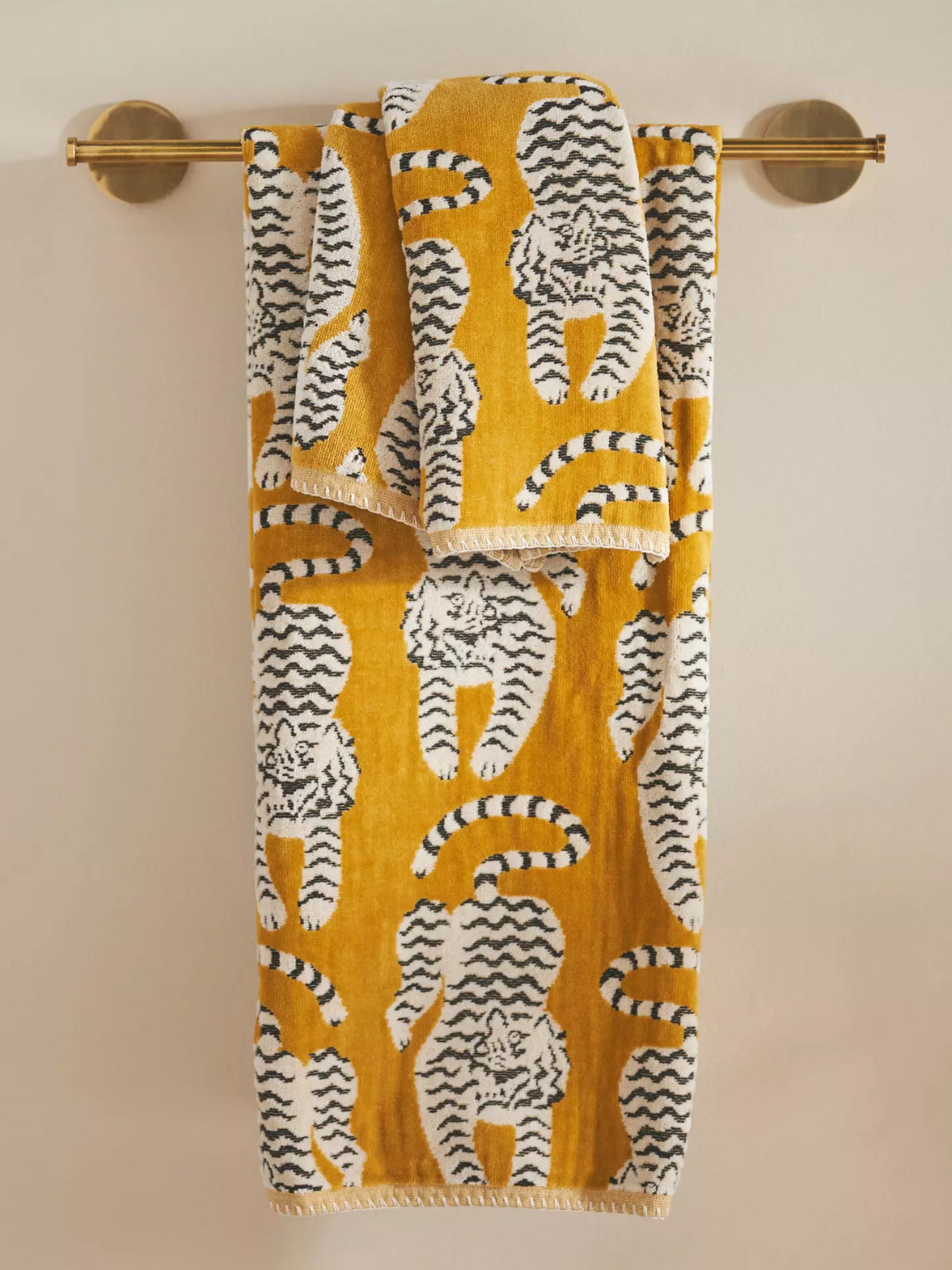 A white and black tiger pattern on a mustard towel from Anthropologie