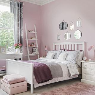 Pink bedroom walls with white bedroom furniture and white and pink bedding