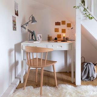 home office understairs with wooden desk and lighting