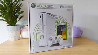 MEGA Xbox 360 kit box sitting on woodgrain surface