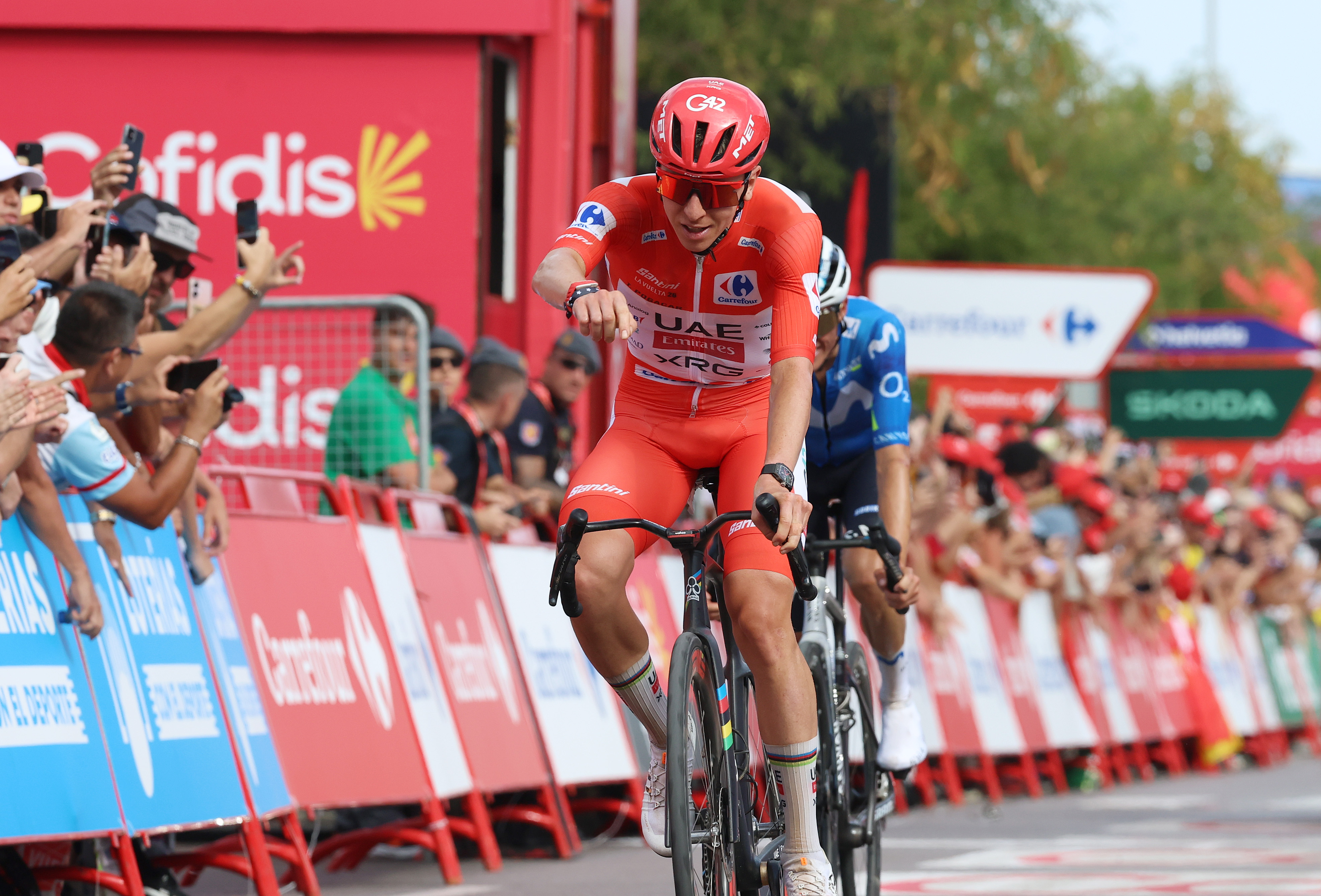 Tadej Pogačar in red celebrates winning stage six of the Vuelta a Espa&ntilde;a 2026
