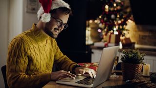 man using laptop at Christmas