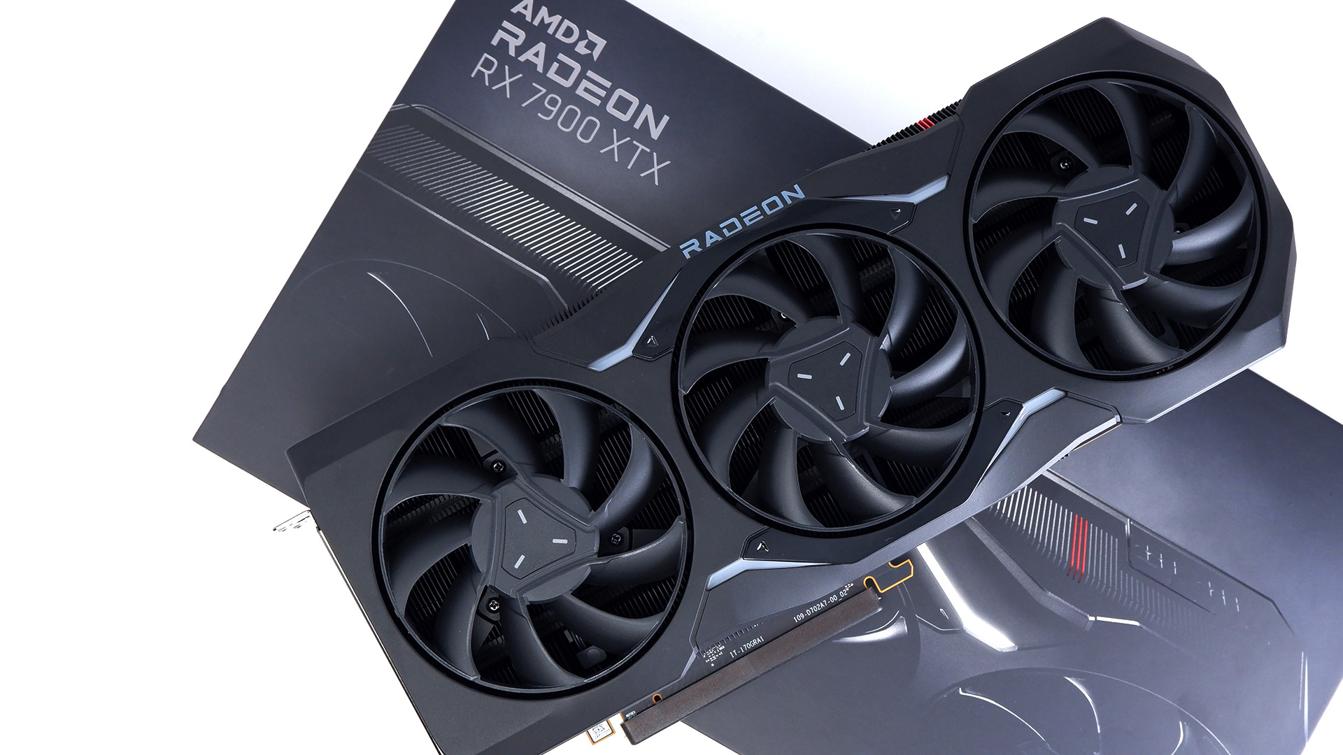 AMD Radeon RX 7900 XTX photographed with box on a white background.