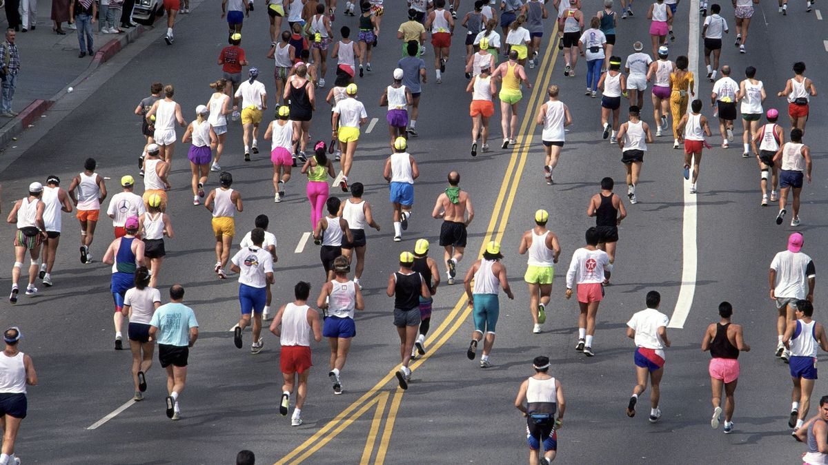 Aerial view of participants in a road race running uphill