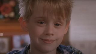 Macaulay Cullkin as Kevin McCallister sporting a menacing grin in Home Alone