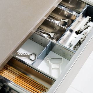 stainless steel utensil drawer with kitchen utensils