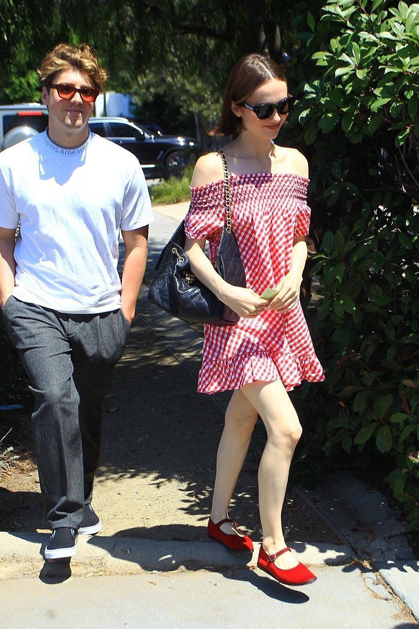 Maude Apatow wearing a Frankies Bikinis red gingham dress and red Mary Janes