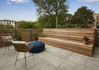 An outdoor bench that has been integrated into the fence design