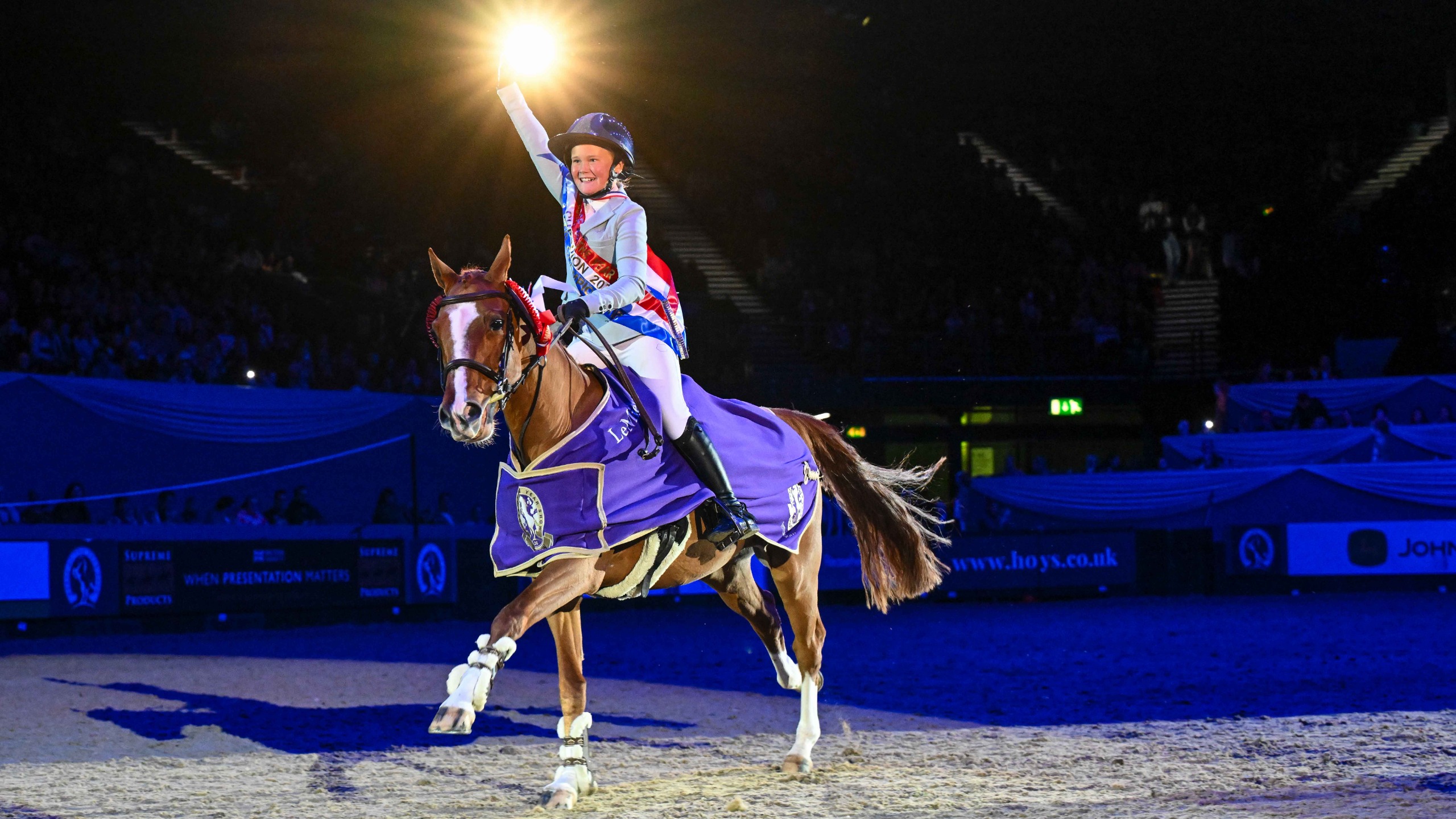 Anya Dewey Clarke celebrates on her victory lap at HOYS 2026